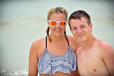 Portrait of smiling man wearing sunglasses at beach