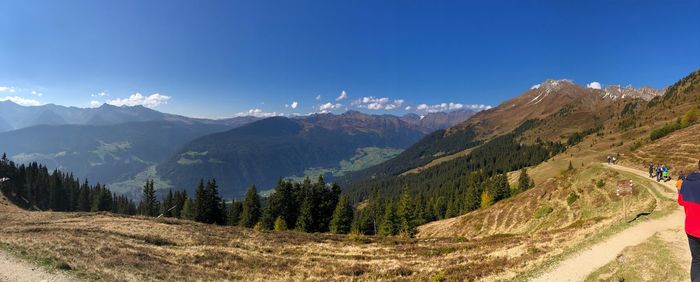 Scenic view of landscape and mountains against blue sky