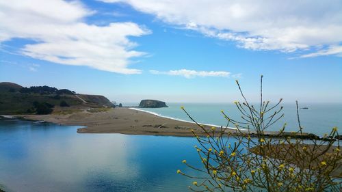 Scenic cliff view of russian river sandbar merging with the pacific ocean against soft sky