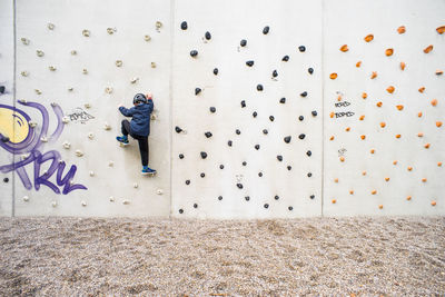 Full length of boy wall climbing at playground