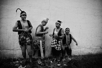 Portrait of people standing against wall