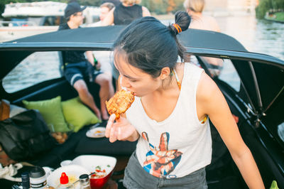 High angle view of woman eating steak at boat