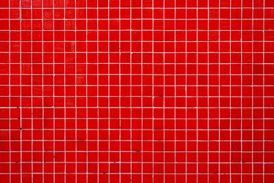 Background from a wall made of red mosaic tiles