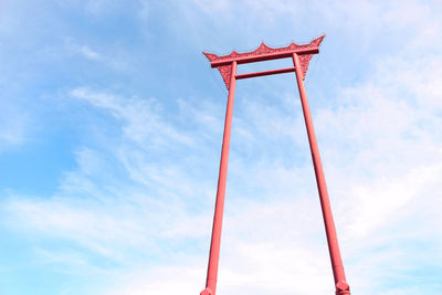 Low angle view of red flag against sky