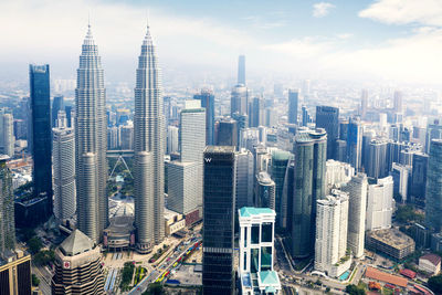 Aerial view of modern buildings in city against sky