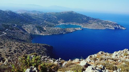 High angle view of sea and mountains against sky