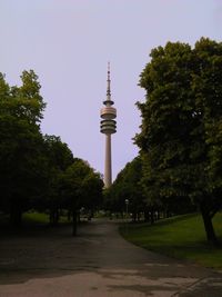 Trees in city against clear sky