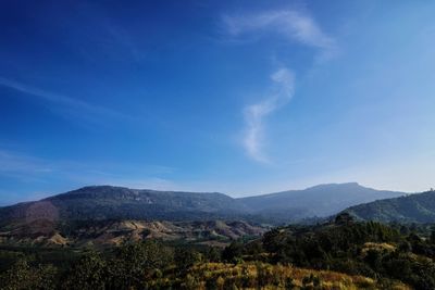 Scenic view of landscape against blue sky