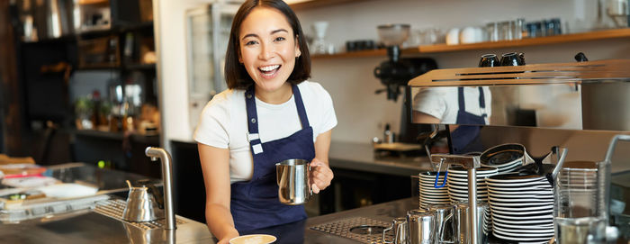 Portrait of young woman sitting in cafe