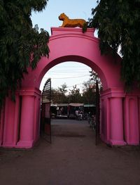 Pink entrance to building against sky