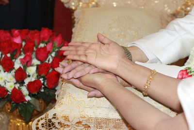 Cropped image of bride and groom during wedding ceremony