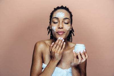 Portrait of young woman drinking water