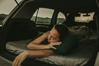 Low section of man sitting in car