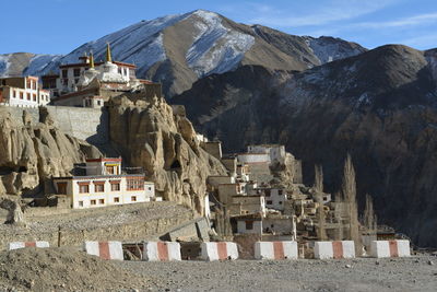 Town by mountains against sky