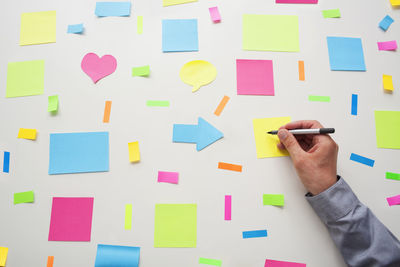 Low section of man holding paper with text