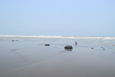 Scenic view of beach against clear sky