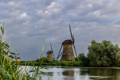 Beautiful wooden windmills at sunset in the dutch village of kinderdijk. windmills run on the wind.