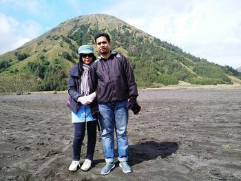 Portrait of couple standing against mountain