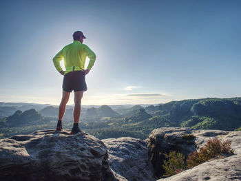 Silhouette of athlete runner on sunset background. sportsman with sportive figure practices sport