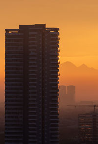 Buildings against sky during sunset