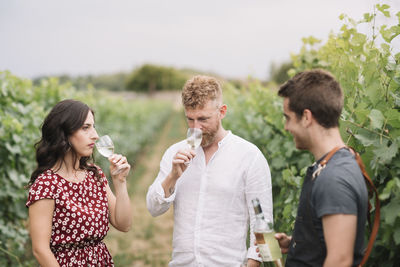 Sommelier explaining customers wine in the vineyard