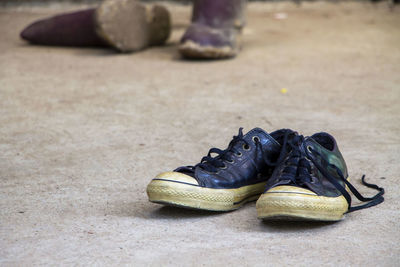 Low section of man wearing shoes on street