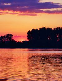 Scenic view of lake against romantic sky at sunset