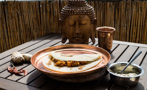 Close-up of buddha statue on table