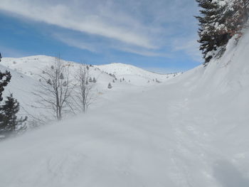 Scenic view of snow covered mountains against sky