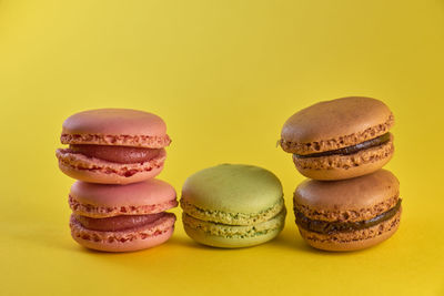 Close-up of cupcakes against yellow background