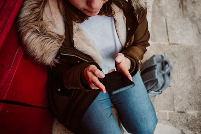 Midsection of woman holding umbrella in winter