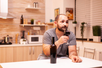 Portrait of senior man drinking glass