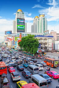 View of city street and buildings against sky