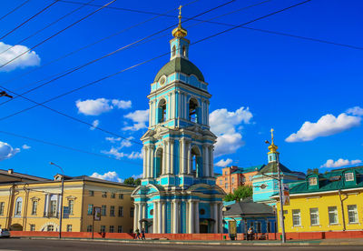 Low angle view of buildings against blue sky