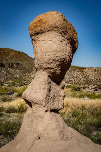 Close-up of rock formation against sky