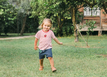Full length of a boy standing on grass