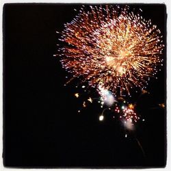 Low angle view of firework display at night