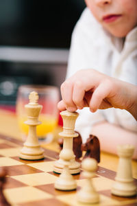 Low angle view of man playing with chess