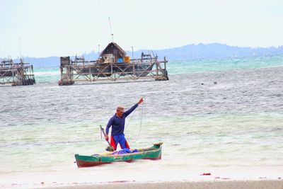 Man on beach against clear sky