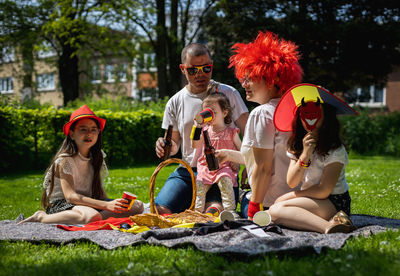 Portrait of a young family with children on a picnic.