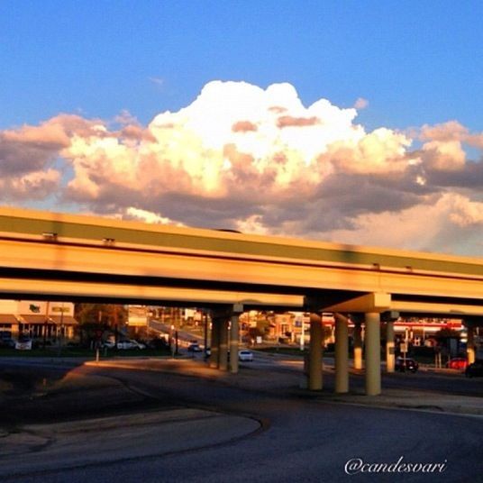 transportation, mode of transport, car, land vehicle, sky, road, street, built structure, architecture, road marking, cloud - sky, on the move, building exterior, travel, public transportation, incidental people, city, cloud, the way forward, outdoors