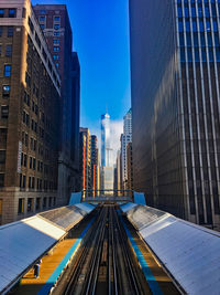 Modern buildings in city against blue sky