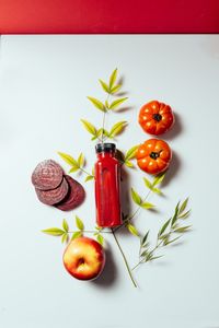 High angle view of fruits on table against white background