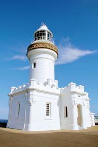 Low angle view of lighthouse against building