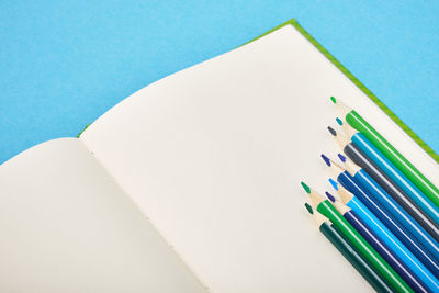 High angle view of colored pencils against white background