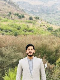 Portrait of young man standing on land