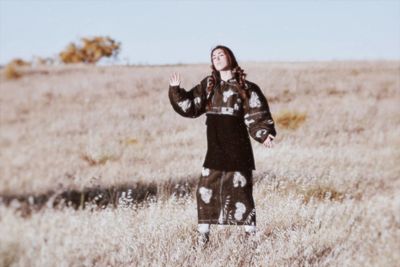 Full length of woman standing on field