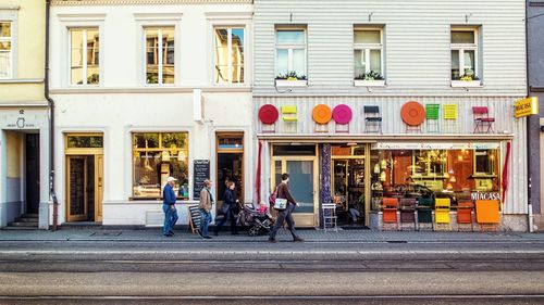 People at sidewalk cafe in city