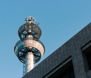 Low angle view of water tower against clear sky