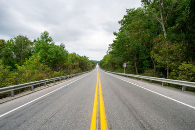 A shot from the center of a road with the norman wood bridge up ahead